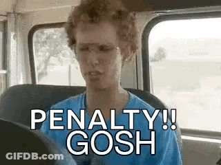 A Man Is Sitting In A Bus With A Cigarette In His Mouth . GIF