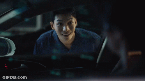 A Man Is Sitting In A Car And Smiling GIF
