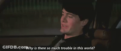 A Man Is Sitting In A Car And Talking To Someone . GIF