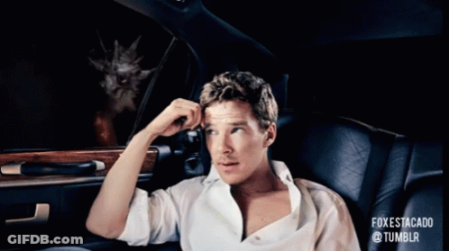 A Man Is Sitting In A Car Looking Out The Window At A Cat With Flames Coming Out Of It GIF