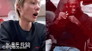 A Man Is Sitting In A Car Next To A Man In A Black Shirt . GIF