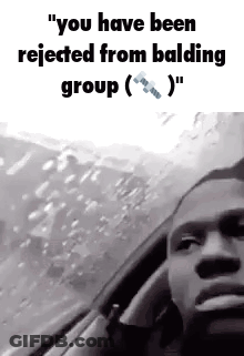 A Man Is Sitting In A Car Talking On A Cell Phone . GIF