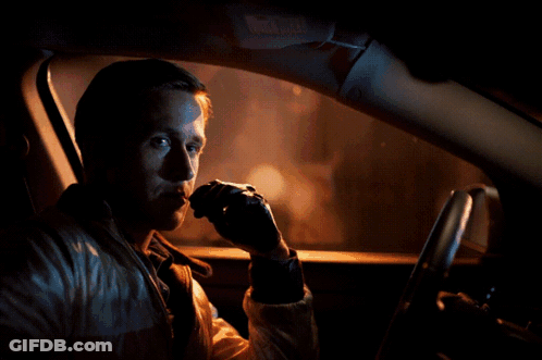 A Man Is Sitting In A Car With A Red Arrow Pointing To His Face GIF