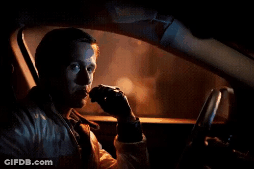 A Man Is Sitting In A Car With A Red Arrow Pointing To His Face GIF