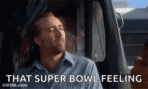 A Man Is Sitting In A Car With His Eyes Closed And The Words That Super Bowl Feeling Above Him GIF