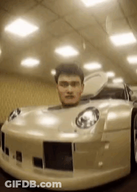 A Man Is Sitting In A Car With His Head In The Trunk . GIF