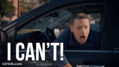 A Man Is Sitting In A Car With His Mouth Open And Shouting . GIF