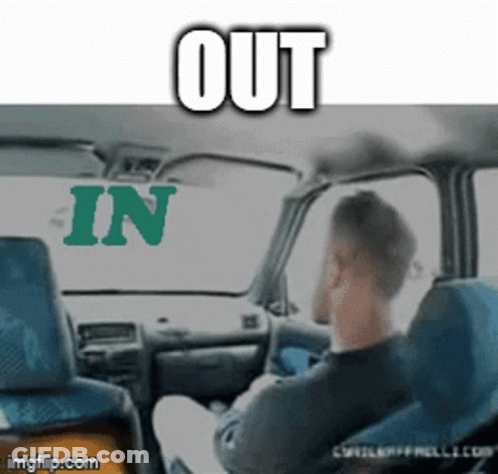 A Man Is Sitting In A Car With The Words Out And In Behind Him GIF