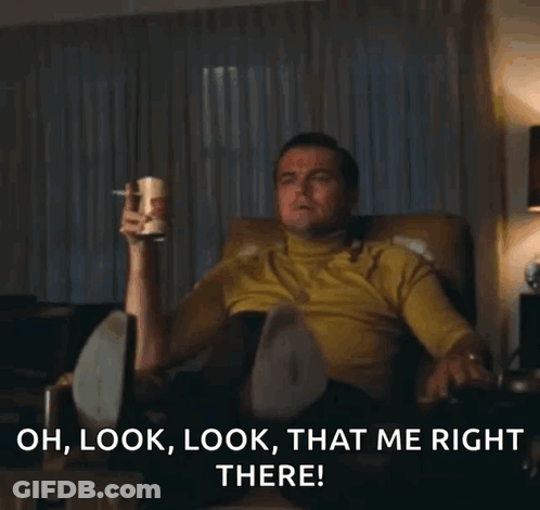 A Man Is Sitting In A Chair And Pointing At Something With The Words Oh Look Look That Me Right There Below Him GIF