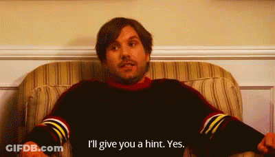 A Man Is Sitting In A Chair And Saying I 'Ll Give You A Hint . GIF