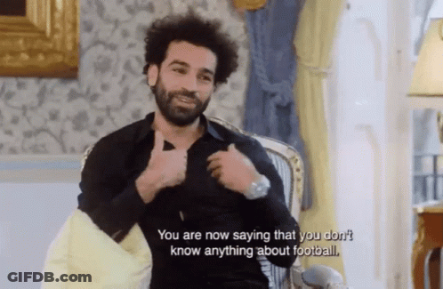 A Man Is Sitting In A Chair And Talking About Football GIF