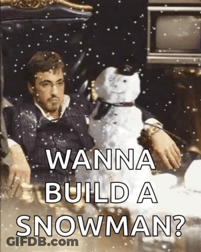 A Man Is Sitting In A Chair Holding A Snowman With The Words " Wanna Build A Snowman " On The Bottom GIF