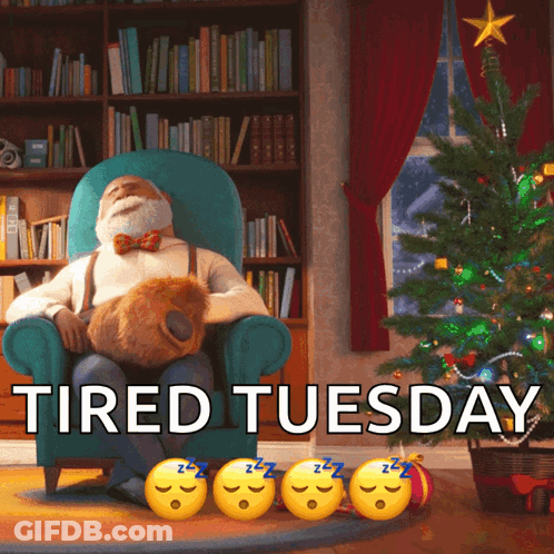 A Man Is Sitting In A Chair In Front Of A Christmas Tree With The Words " Tired Tuesday " On The Bottom GIF
