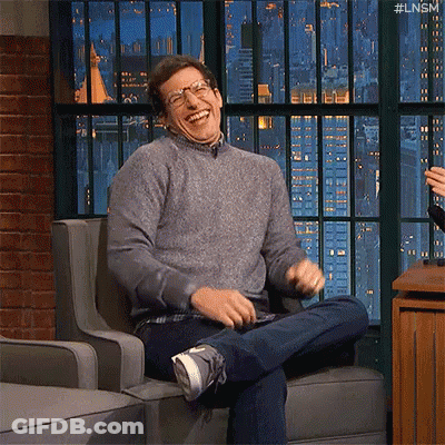 Man Sitting Laughing In Glasses And Sweater GIF