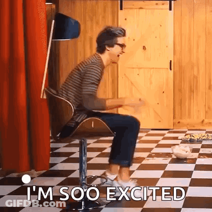 A Man Is Sitting In A Chair On A Checkered Floor And Says `` I 'M Soo Excited '' . GIF