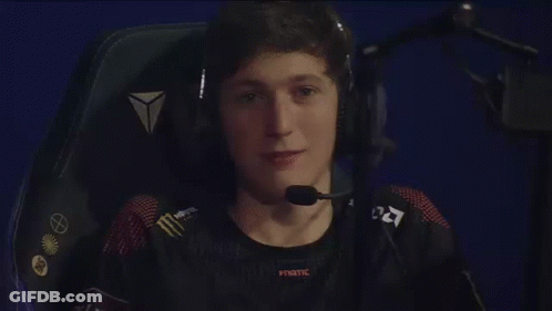 A Man Is Sitting In A Chair Wearing Headphones And A Microphone . GIF