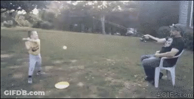 A Man Is Sitting In A Chair While A Boy Throws A Frisbee In The Air . GIF