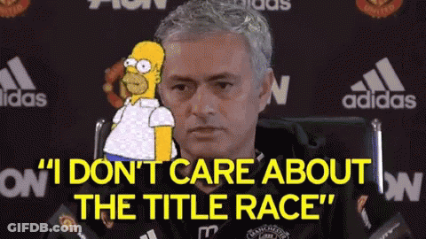 A Man Is Sitting In A Chair With A Cartoon Of Homer Simpson Behind Him . GIF