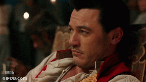 A Man Is Sitting In A Chair With A Imdb Logo In The Corner GIF