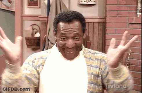 A Man Is Sitting In A Chair With His Arms Outstretched And Smiling . GIF