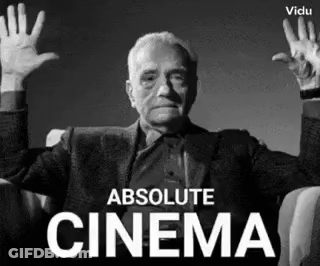 A Man Is Sitting In A Chair With His Hands In The Air And The Words Absolute Cinema Behind Him GIF