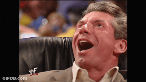 A Man Is Sitting In A Chair With His Mouth Open And A W Logo On His Sleeve GIF
