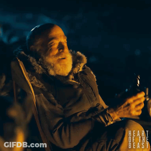 A Man Is Sitting In A Chair With The Words Heart Of The Beast Written On The Bottom GIF