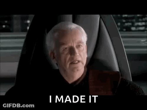 A Man Is Sitting In A Chair With The Words `` I Made It '' Written On The Screen . GIF