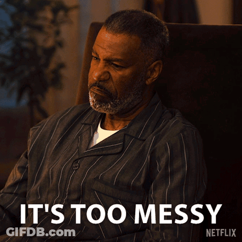 A Man Is Sitting In A Chair With The Words " It 'S Too Messy " Written Below Him GIF