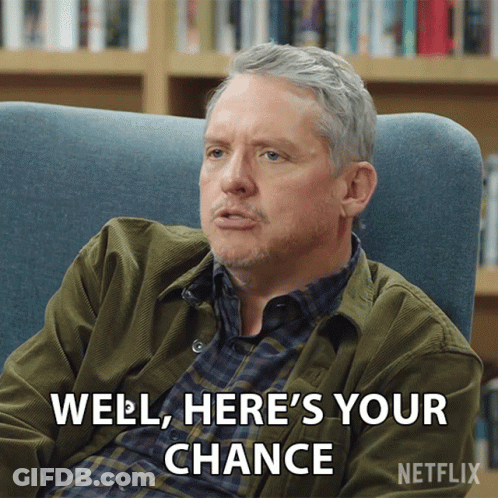 A Man Is Sitting In A Chair With The Words Well Here 'S Your Chance GIF