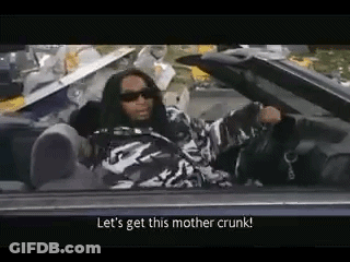 A Man Is Sitting In A Convertible Car Talking To Someone . GIF