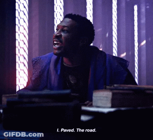 A Man Is Sitting In A Dark Room And Says Paved The Road . GIF
