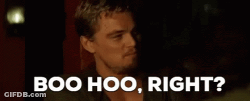 A Man Is Sitting In A Dark Room With The Words `` Boo Hoo , Right ? '' Above Him . GIF
