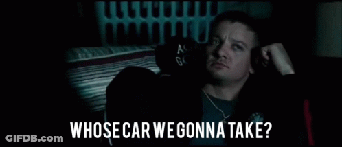 A Man Is Sitting In A Dark Room With The Words `` Whose Car We Gonna Take '' Written On The Bottom . GIF