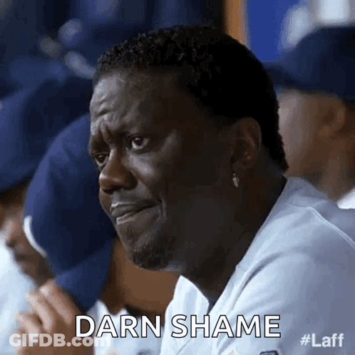 A Man Is Sitting In A Dugout With His Eyes Closed And The Words Darn Shame Written On The Screen . GIF