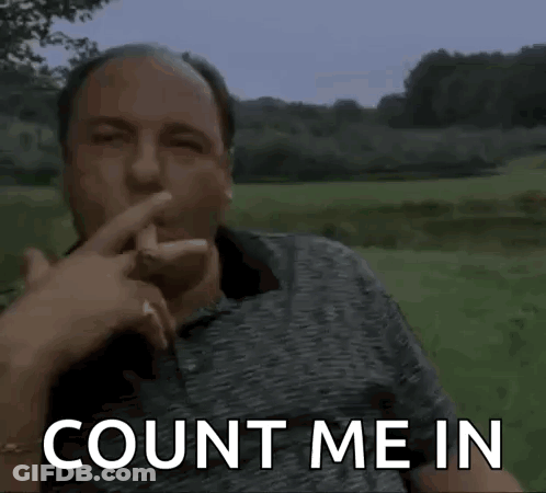 A Man Is Sitting In A Field With His Finger To His Mouth And The Words `` Count Me In '' Written On The Screen . GIF