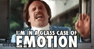 A Man Is Sitting In A Glass Case Of Emotion And Waving . GIF