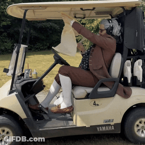 A Man Is Sitting In A Golf Cart That Says Yamaha GIF