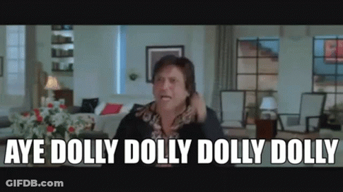 A Man Is Sitting In A Living Room Talking On A Cell Phone And Saying Aye Dolly Dolly Dolly Dolly . GIF