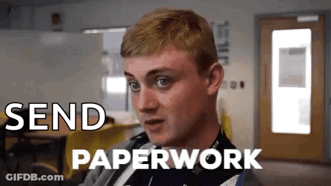 A Man Is Sitting In A Room With The Words Send Paperwork Written On The Screen . GIF