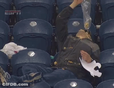 A Man Is Sitting In A Stadium With His Face Covered In Popcorn And A Piece Of Paper .. GIF