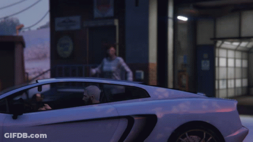 A Man Is Sitting In A White Sports Car While A Woman Stands In The Background GIF