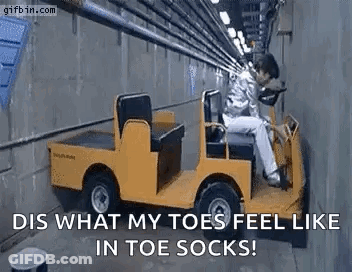 A Man Is Sitting In A Yellow Golf Cart . GIF