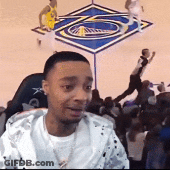 A Man Is Sitting In Front Of A Basketball Court GIF
