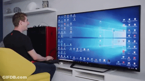 A Man Is Sitting In Front Of A Computer Monitor With A Lot Of Windows Open GIF