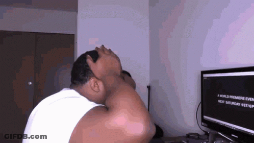 A Man Is Sitting In Front Of A Computer Screen That Says A World Premiere Event GIF
