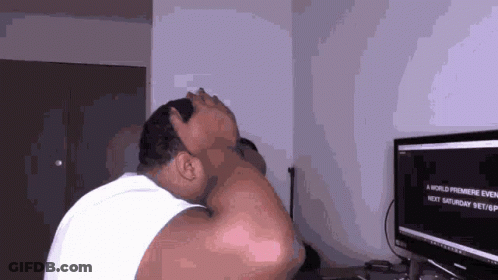 A Man Is Sitting In Front Of A Computer Screen That Says A World Premiere Event GIF