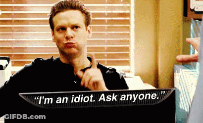 A Man Is Sitting In Front Of A Computer Screen That Says " I 'M An Idiot Ask Anyone " . GIF