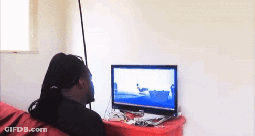 A Man Is Sitting In Front Of A Computer Screen With A Picture Of A Boat On It GIF