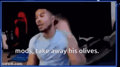 A Man Is Sitting In Front Of A Computer Screen With The Words `` Mods , Take Away His Olives '' Written On It . GIF